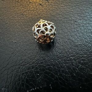Authentic retired Pandora “Picking Daises” openwork charm.